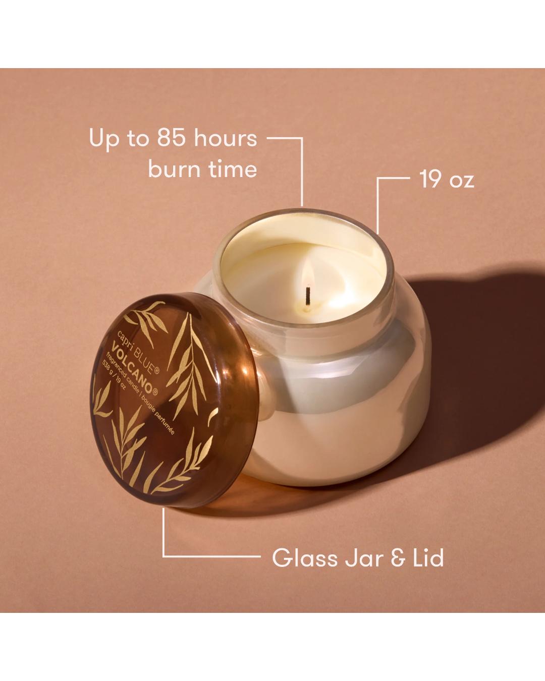 Candle with glass jar and lid on a beige background, showing burn time and weight.