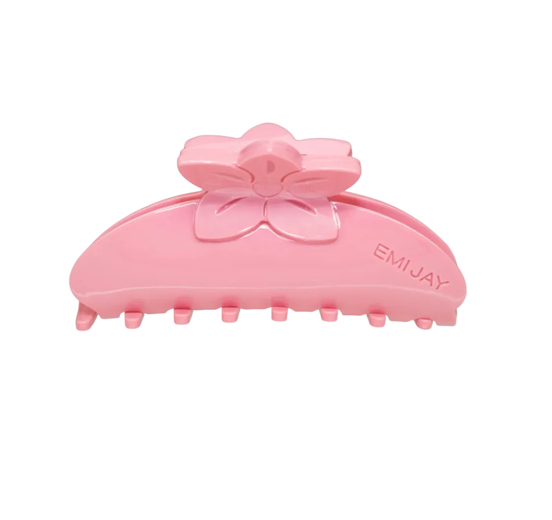 pink claw clip with a flower design on top