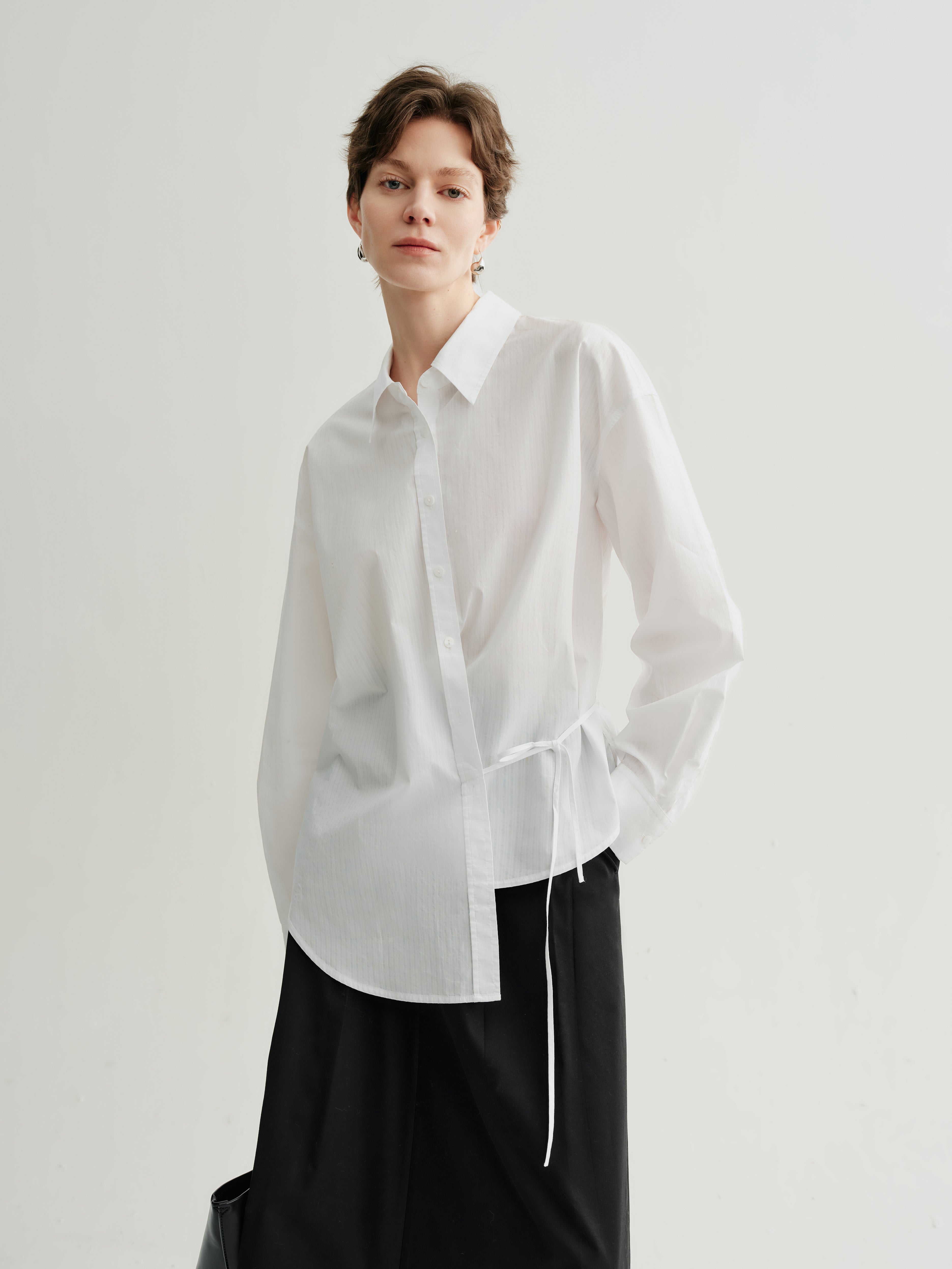 white blouse with a tie at the bottom