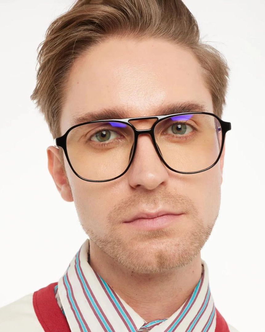 a man wears a pair of black aviator eyeglasses for blue light by Barner