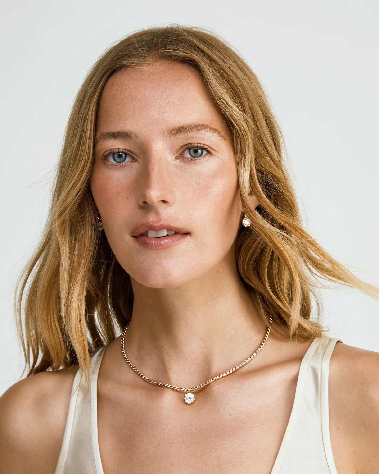 gold rope necklace with circular diamond pendant