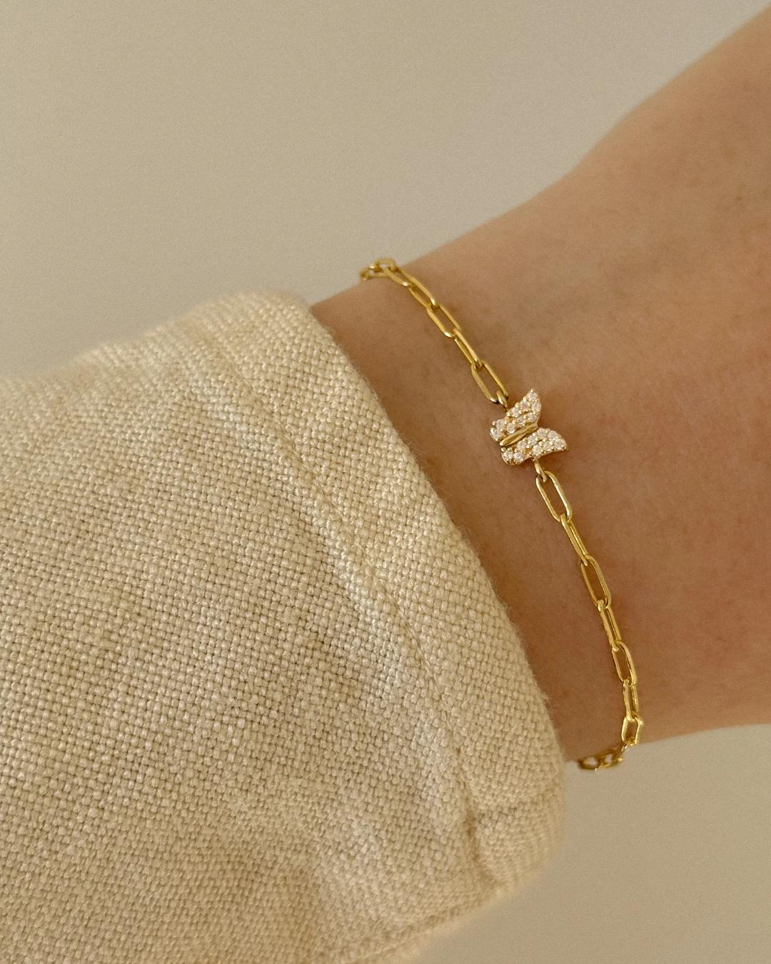 gold link bracelet with a butterfly charm