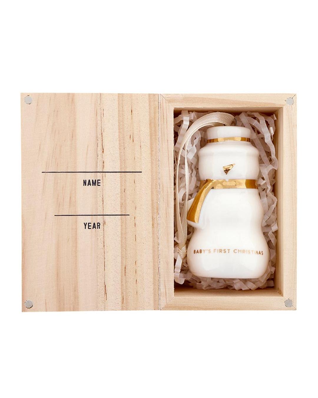 snowman ornament with baby's first christmas on it in text