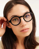 a woman wears a pair of black round framed eyeglasses for blue light by Barner