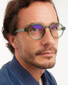 man wearing a pair of green round framed eyeglasses for blue light by Barner