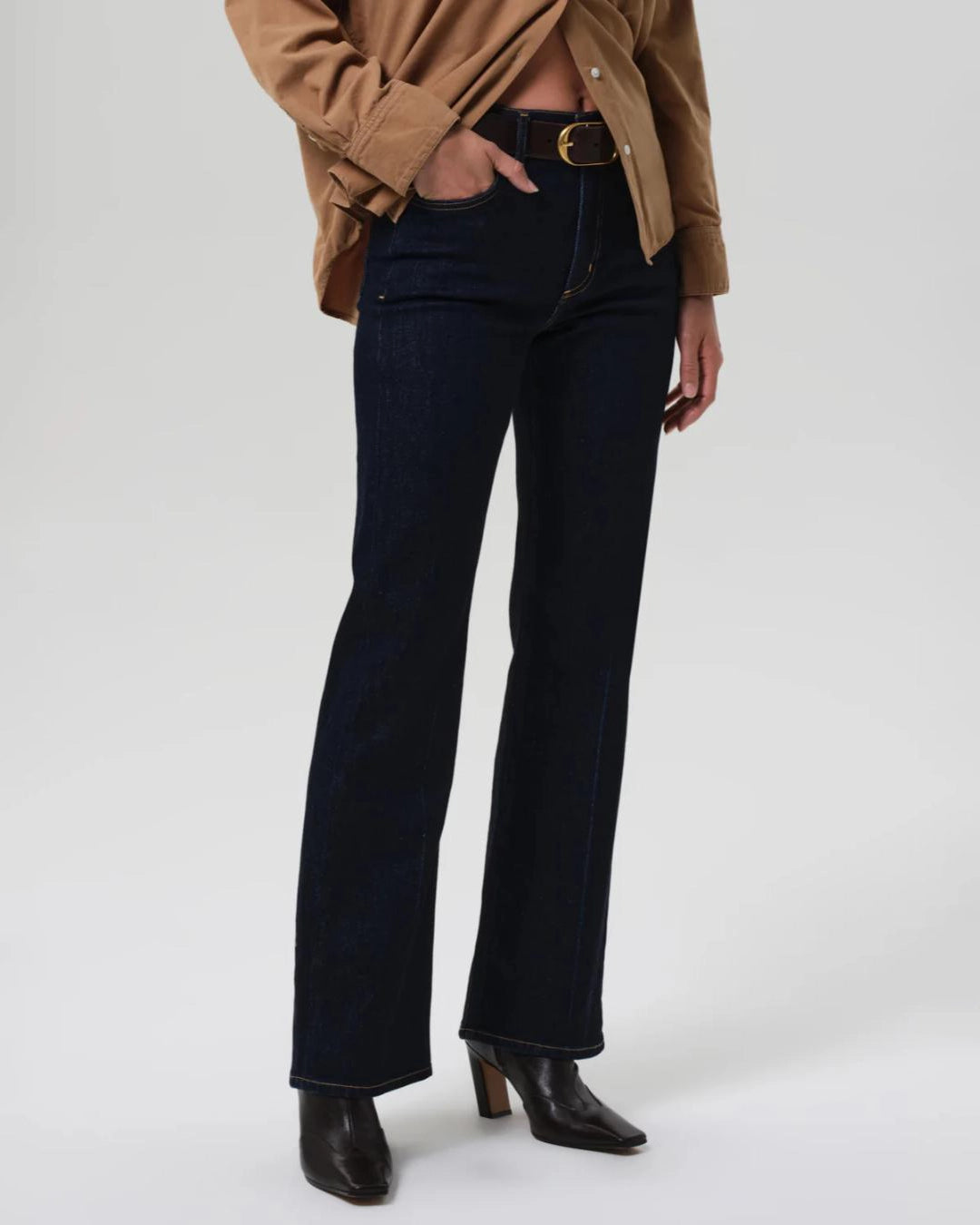 a woman wears a pair of dark wash bootcut Vidia high rise jeans by citizens of humanity
