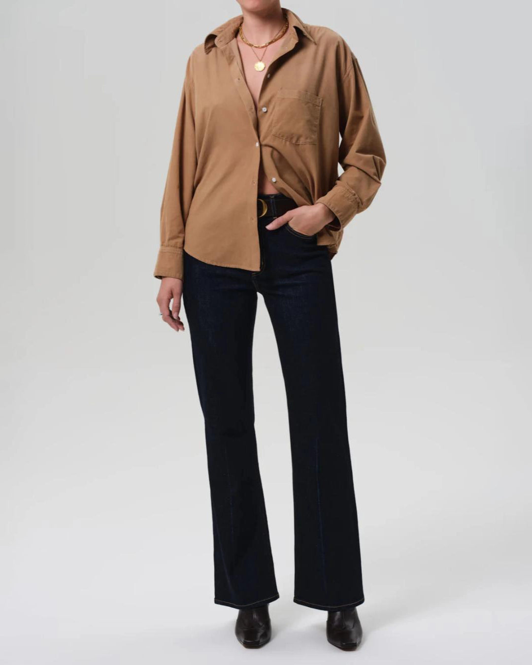 a woman wears a pair of dark wash bootcut Vidia high rise jeans by citizens of humanity