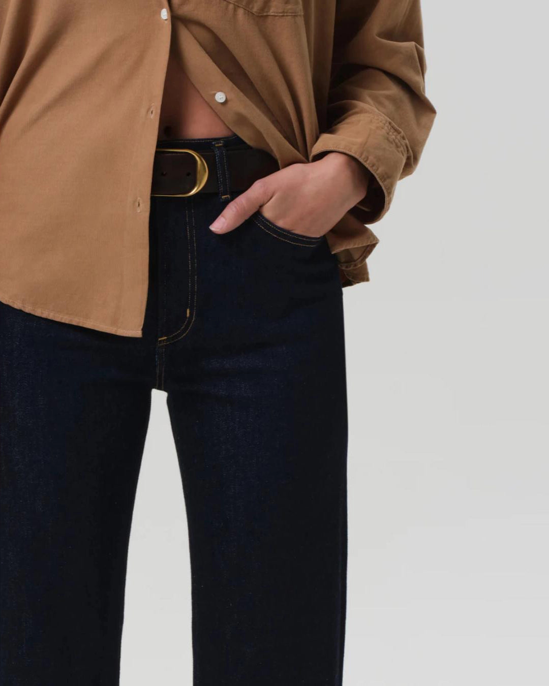 a woman wears a pair of dark wash bootcut Vidia high rise jeans by citizens of humanity