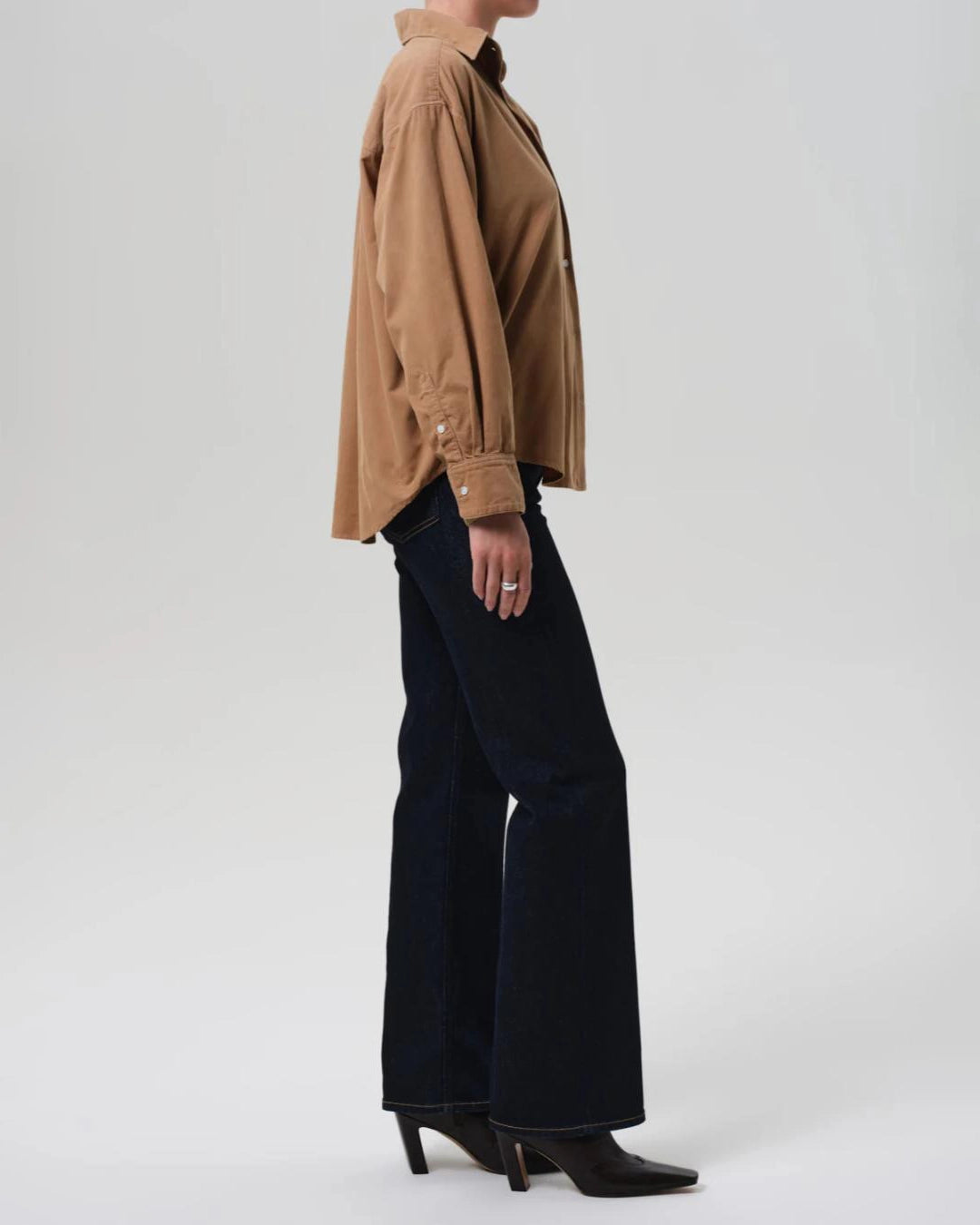 a woman wears a pair of dark wash bootcut Vidia high rise jeans by citizens of humanity