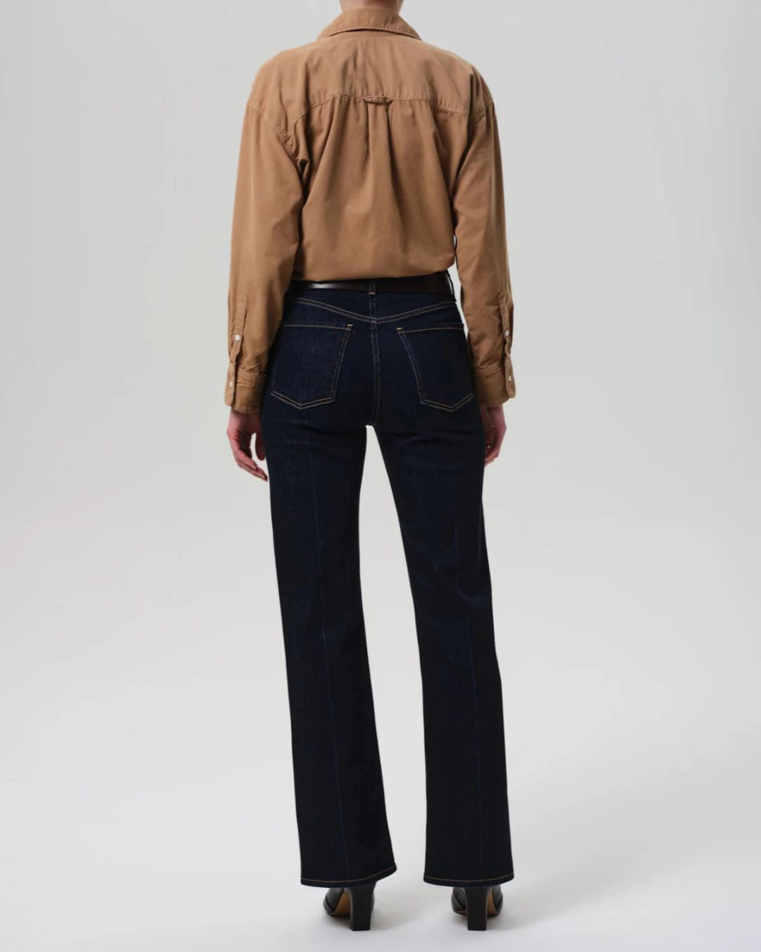 a woman wears a pair of dark wash bootcut Vidia high rise jeans by citizens of humanity