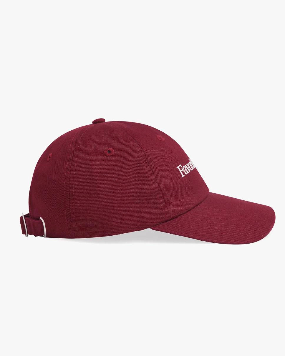 woman wearing a maroon baseball cap with 'Favorite Daughter' text on it