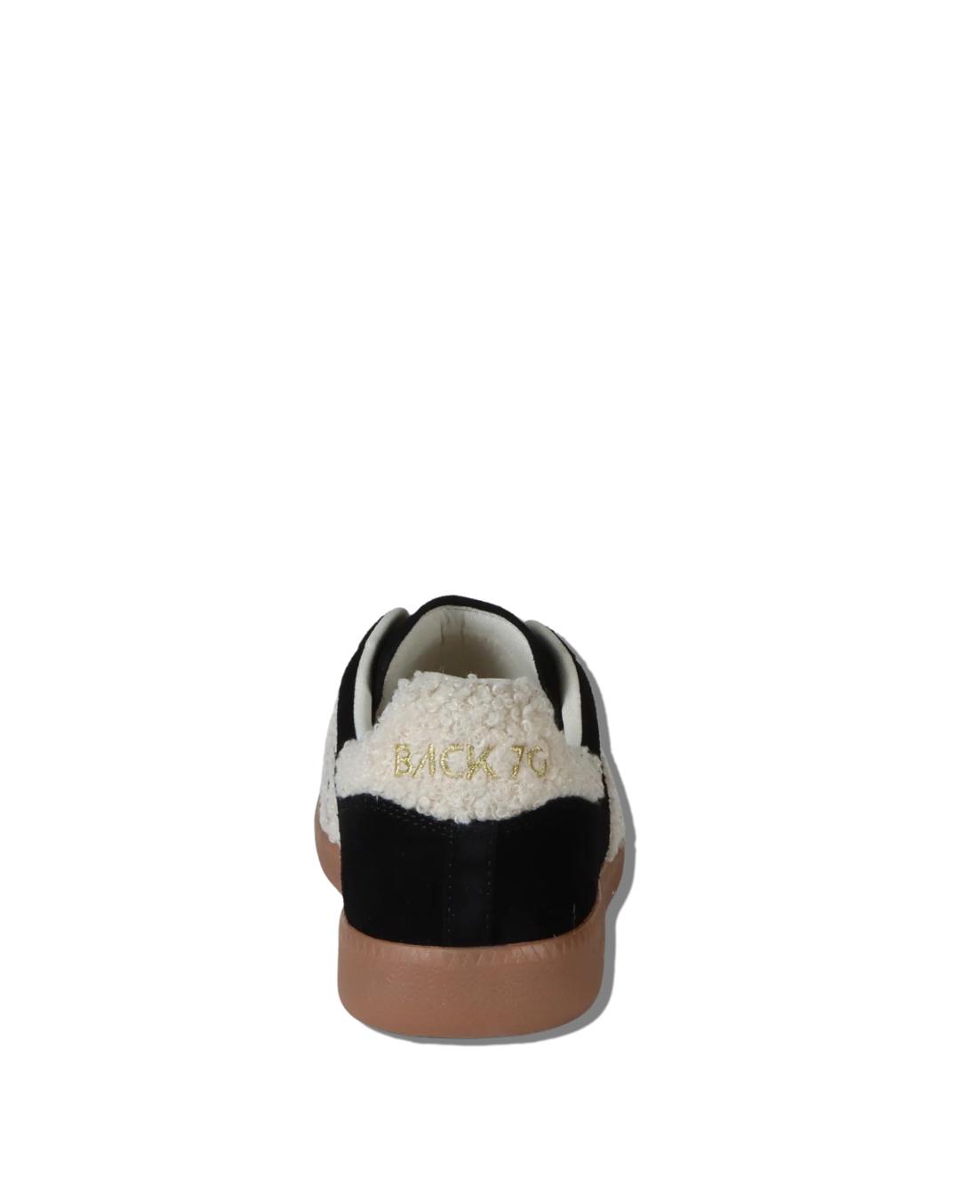 black suede sneaker with 70 written in white