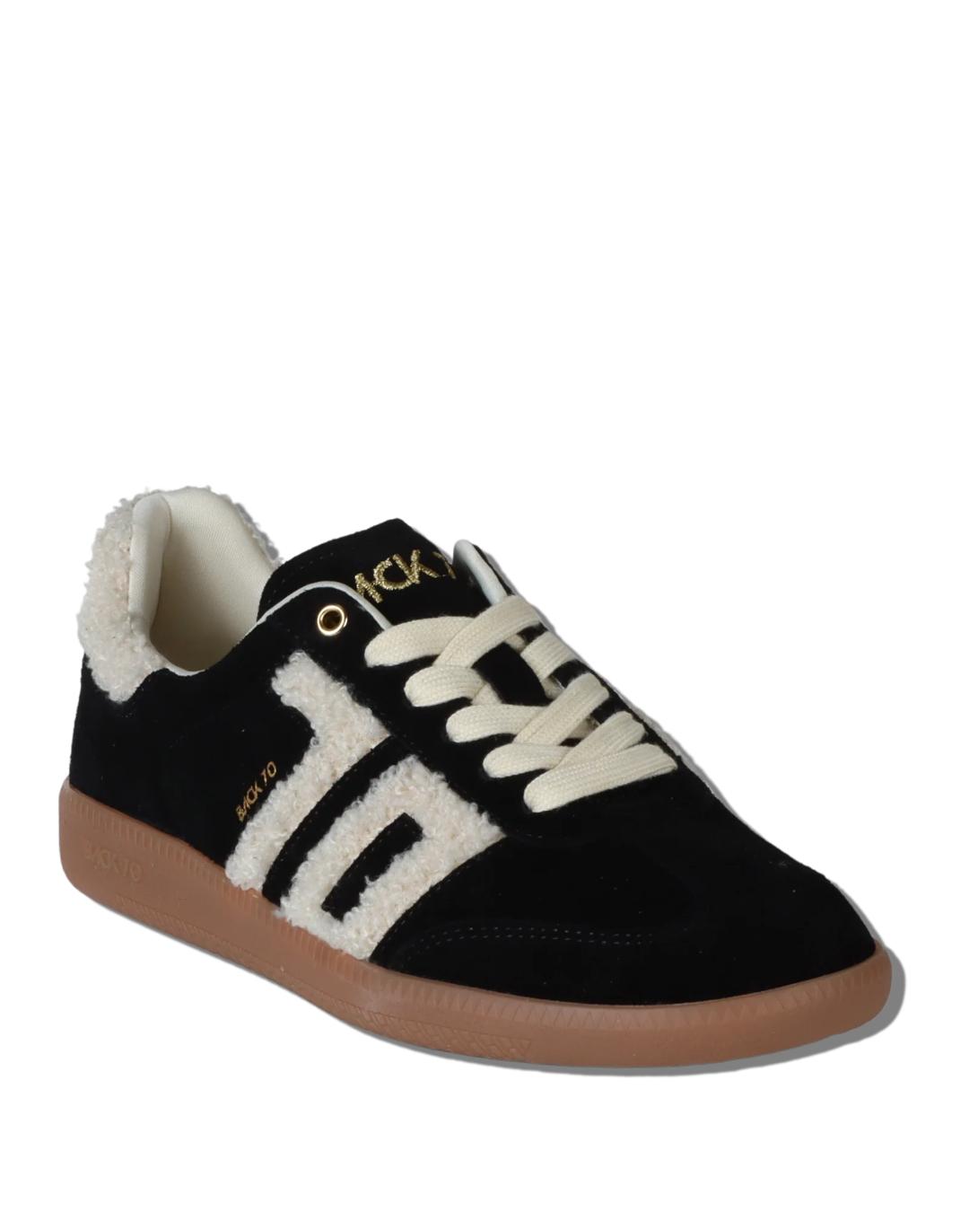 black suede sneaker with 70 written in white