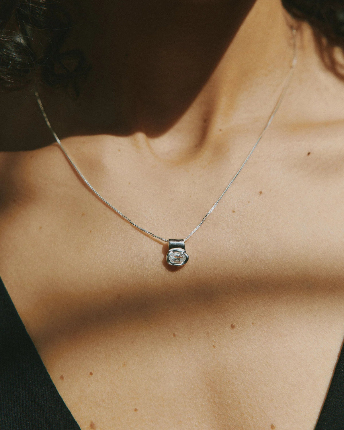 silver necklace with gem pendant