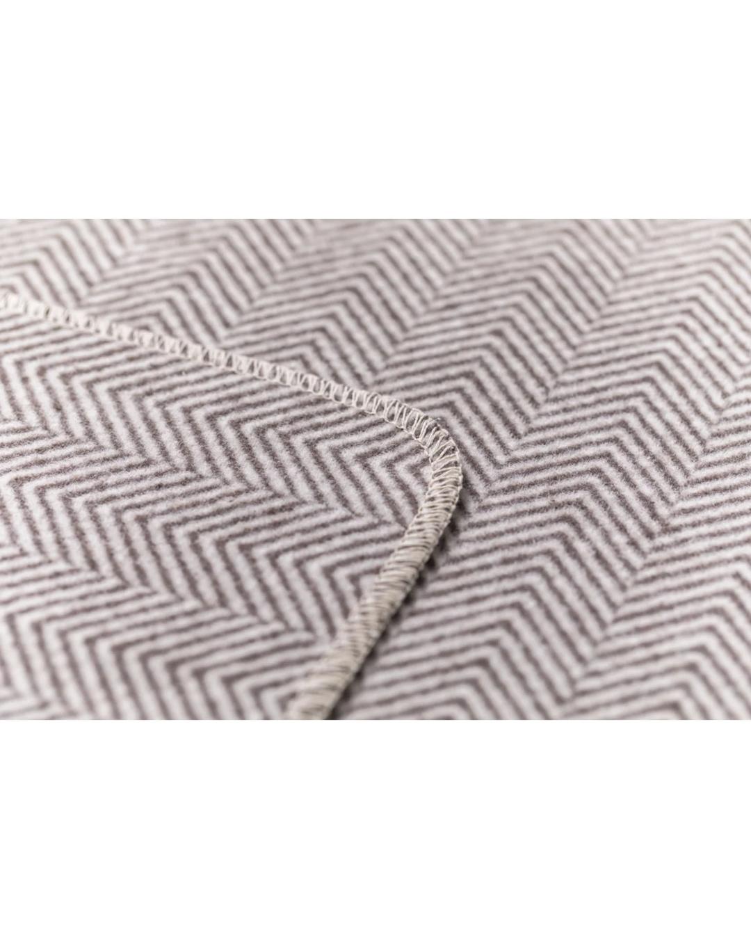 beige blanket with herringbone pattern
