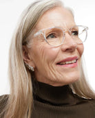 a woman wears a pair of bold clear eyeglasses for blue light by Barner