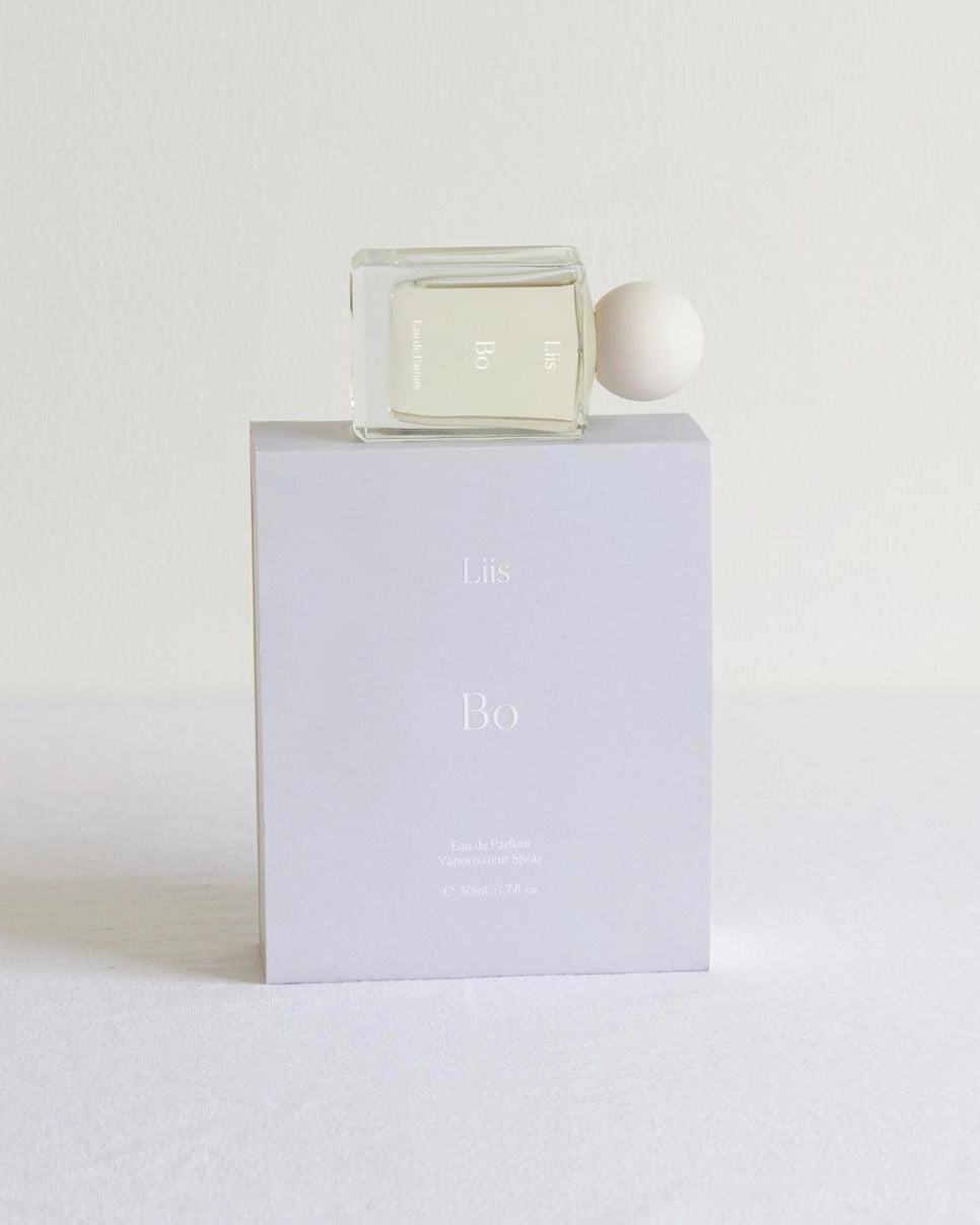 Clear perfume bottle with white cap and 'Bo' writing on it with 'Liis' branding