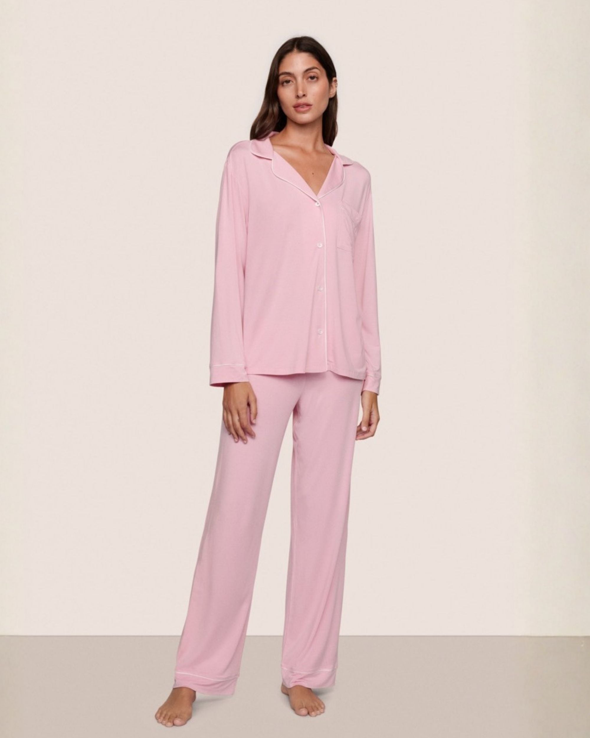 a woman wears pale pink modal pajamas by eberjey