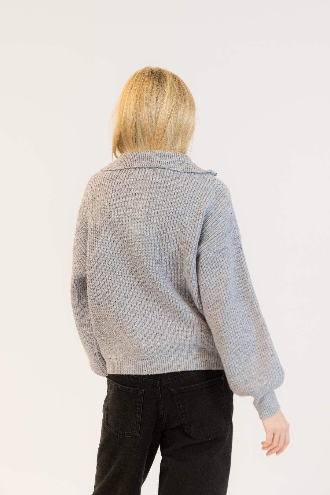back view of a light grey knit half zip sweater
