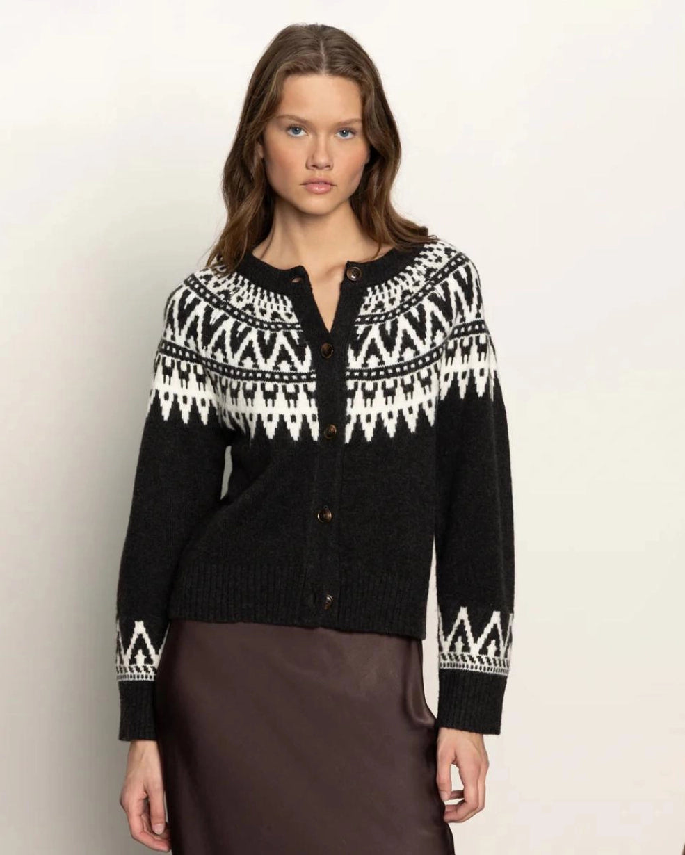 woman wearing a fairisle cardigan in black with white details