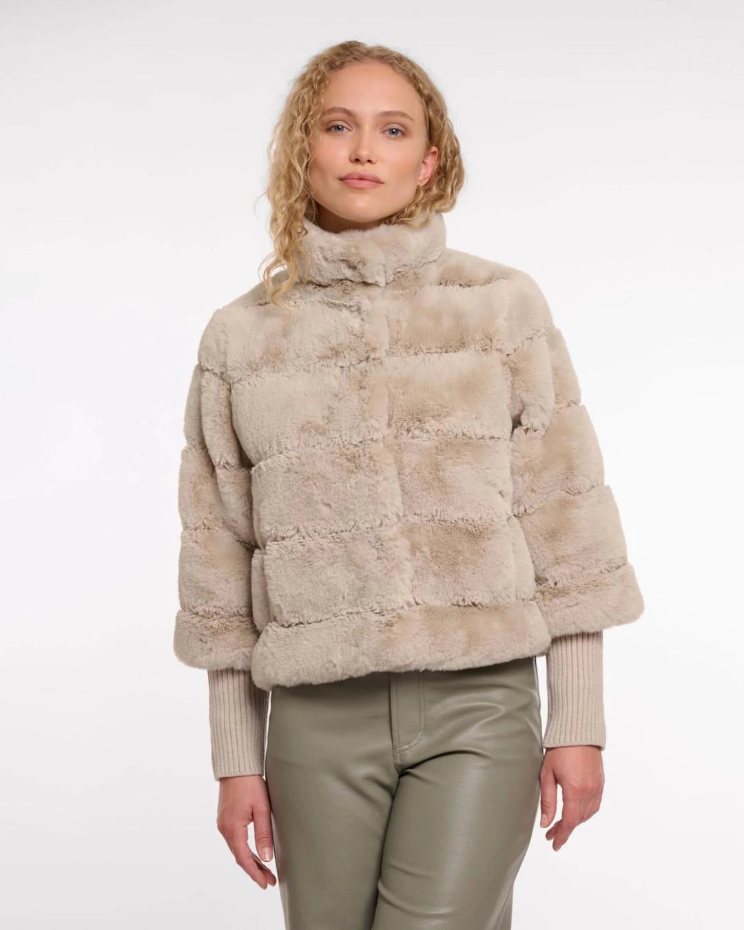 a woman wears a faux fur jacket by Rino & Pelle