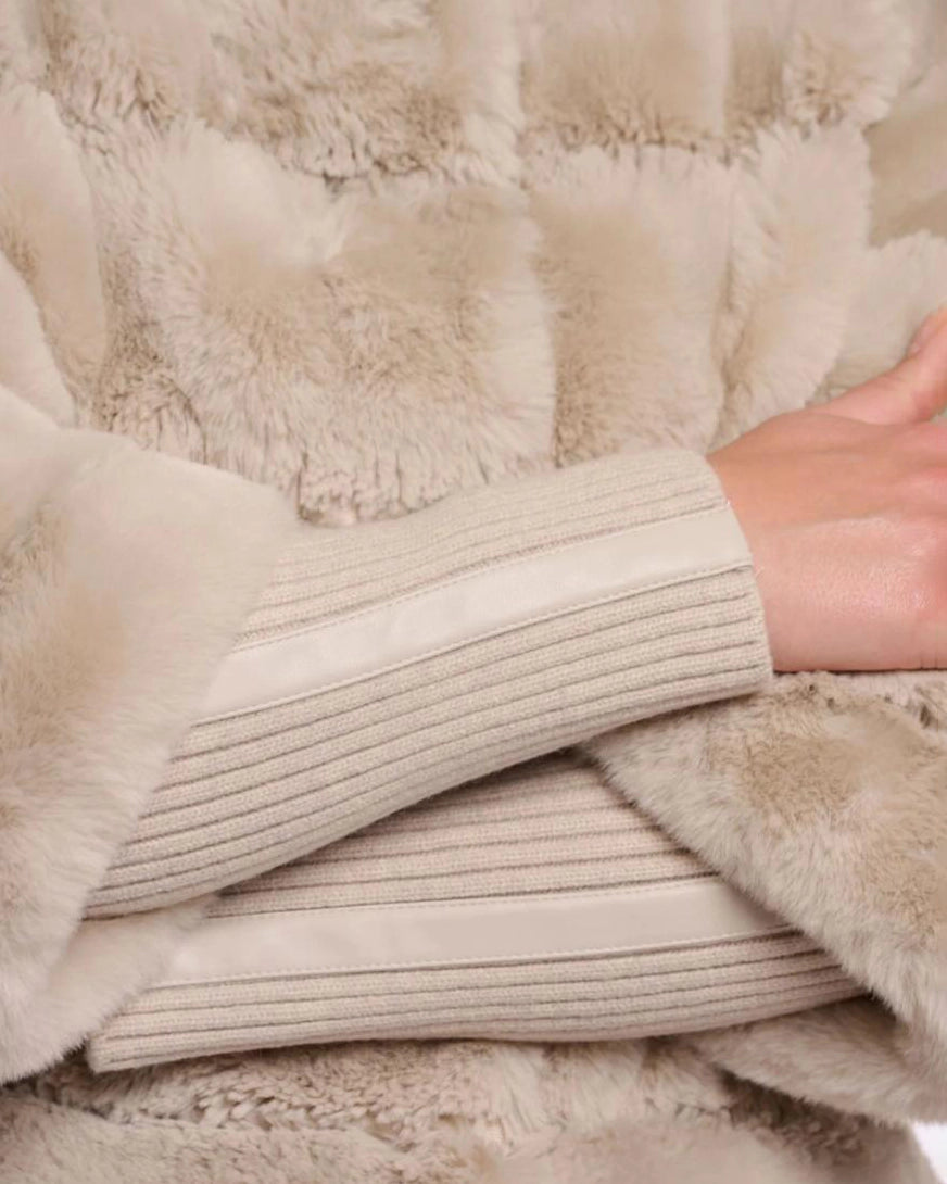 a woman wears a faux fur jacket by Rino & Pelle