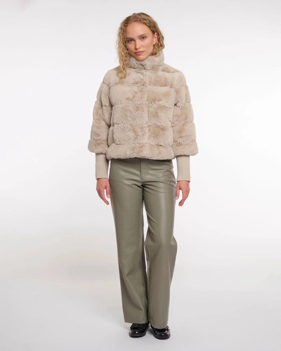 a woman wears a faux fur jacket by Rino & Pelle