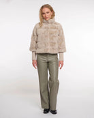 a woman wears a faux fur jacket by Rino & Pelle