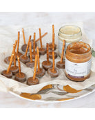 Bites on toothpicks with fig ground mustard on a decorative plate