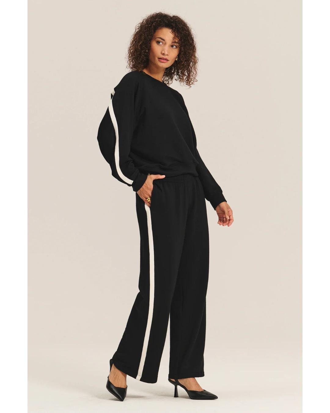 black crewneck sweatshirt with a white stripe across the back and arms