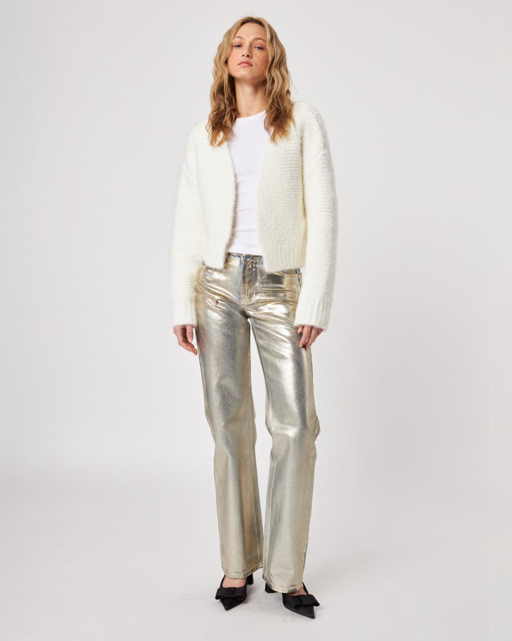 Woman wearing a white fluffy knit cardigan