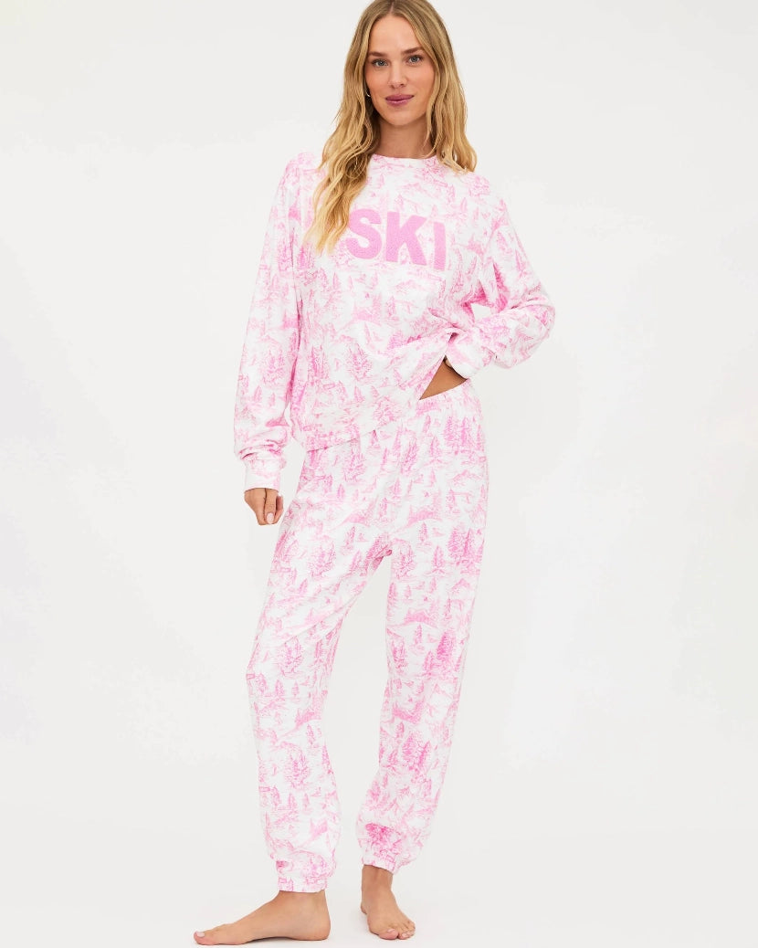 Woman wearing a pink and white toile floral outfit