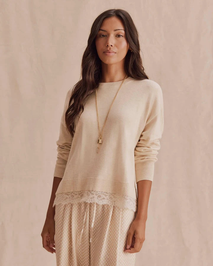 beige knit sweater with lace trim on bottom