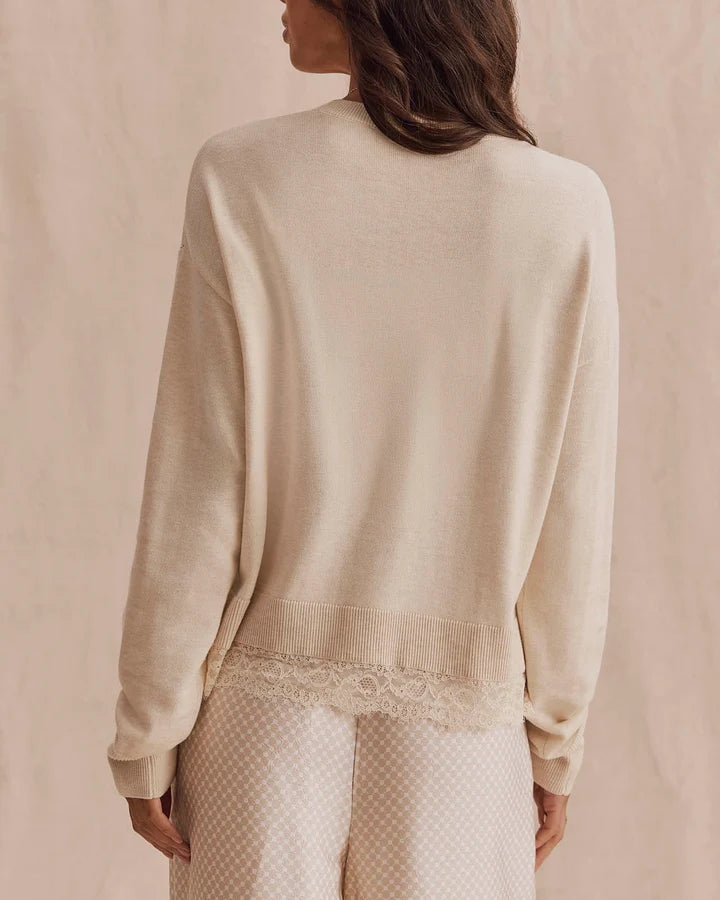 beige knit sweater with lace trim on bottom
