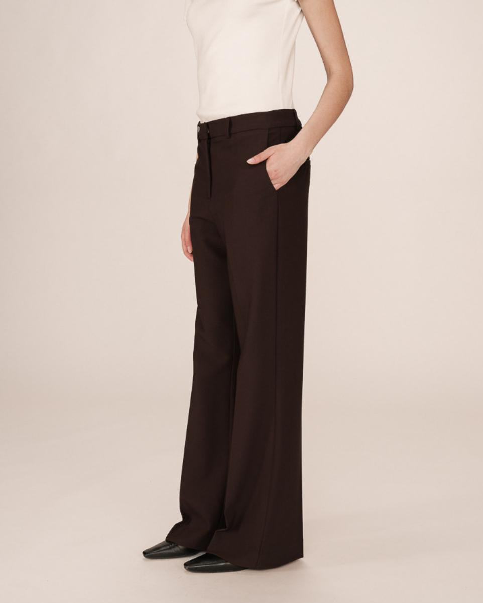 woman wearing brown tailored wide leg pants