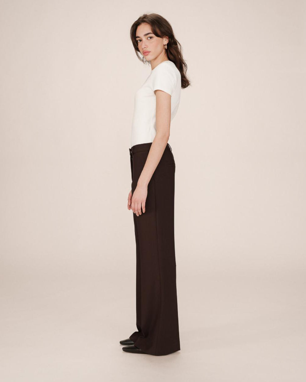 woman wearing brown tailored wide leg pants and white tee