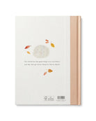 Notebook with a design of a white flower and autumn leaves on a beige cover.