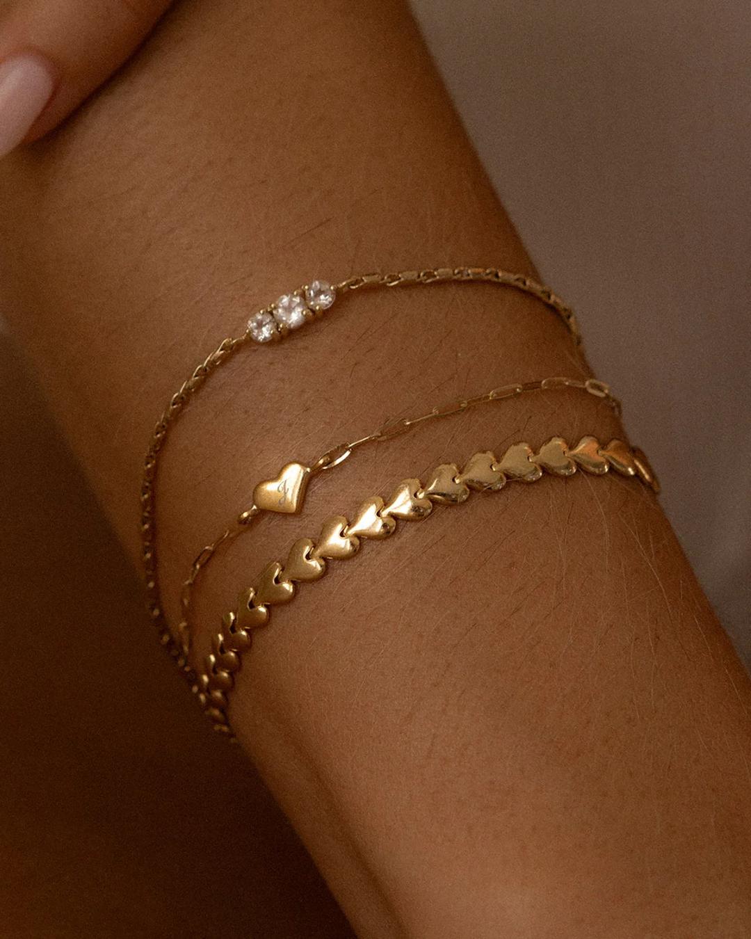 gold herringbone bracelet in the shape of hearts