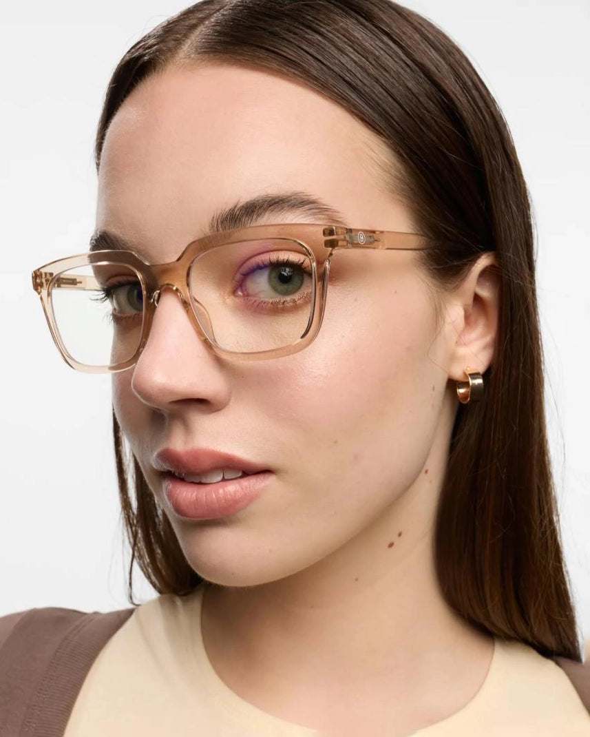 a woman wears a pair of clear pink eyeglasses for blue light by Barner