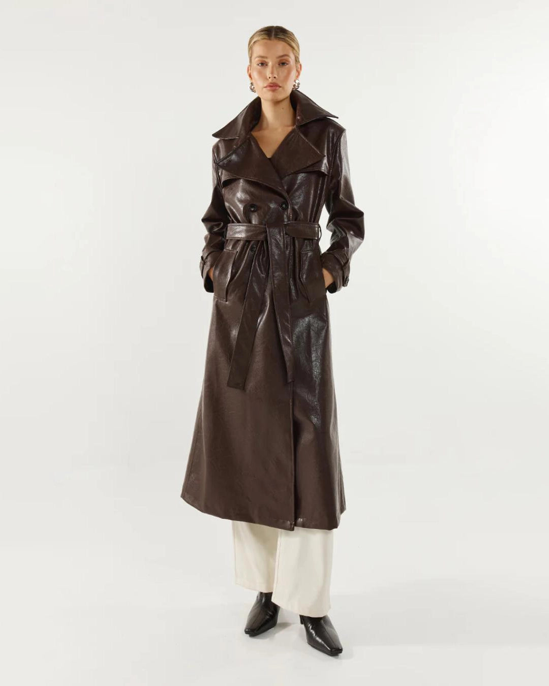 Woman wearing a long brown leather coat