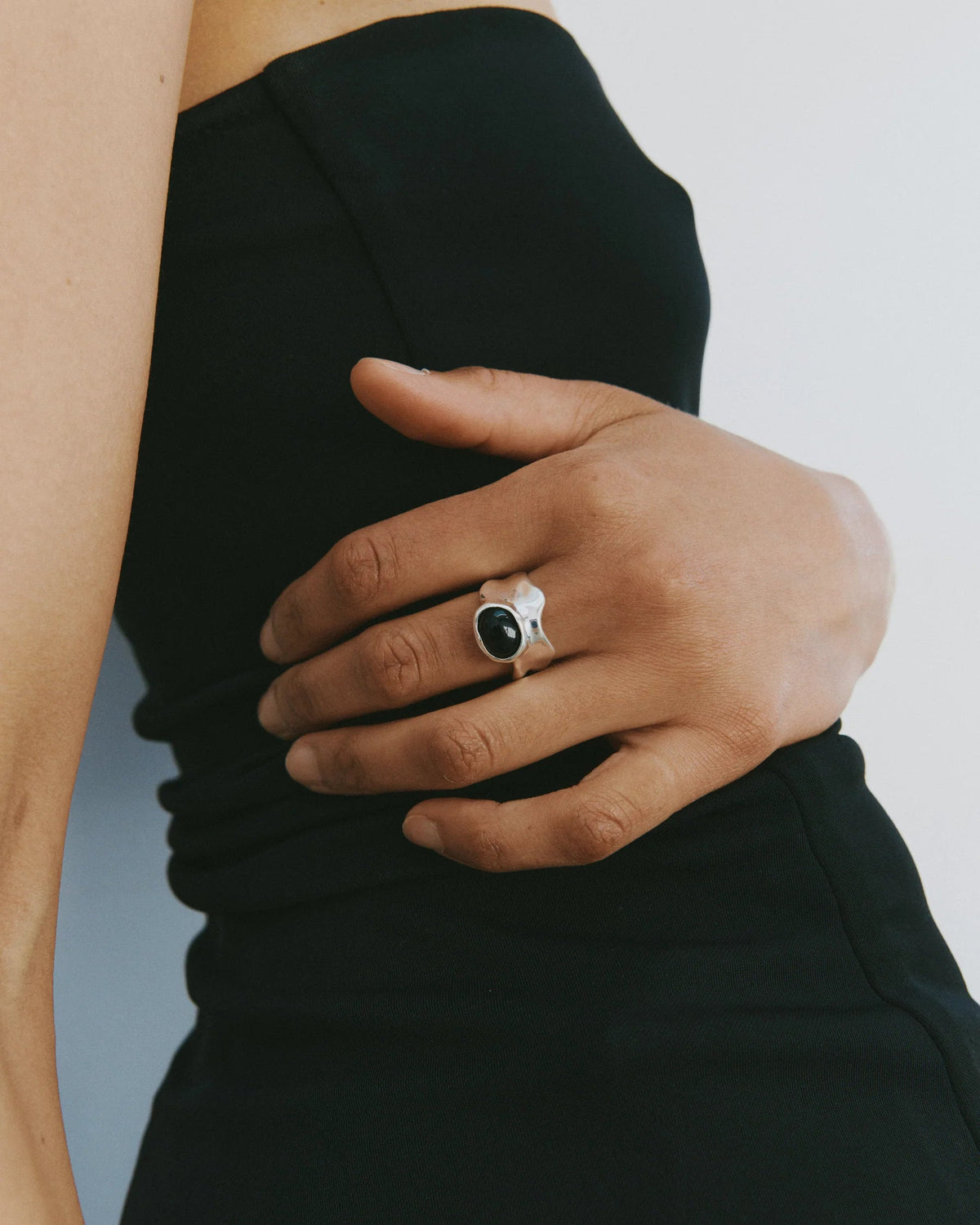 silver ring with black onyx gem in the middle
