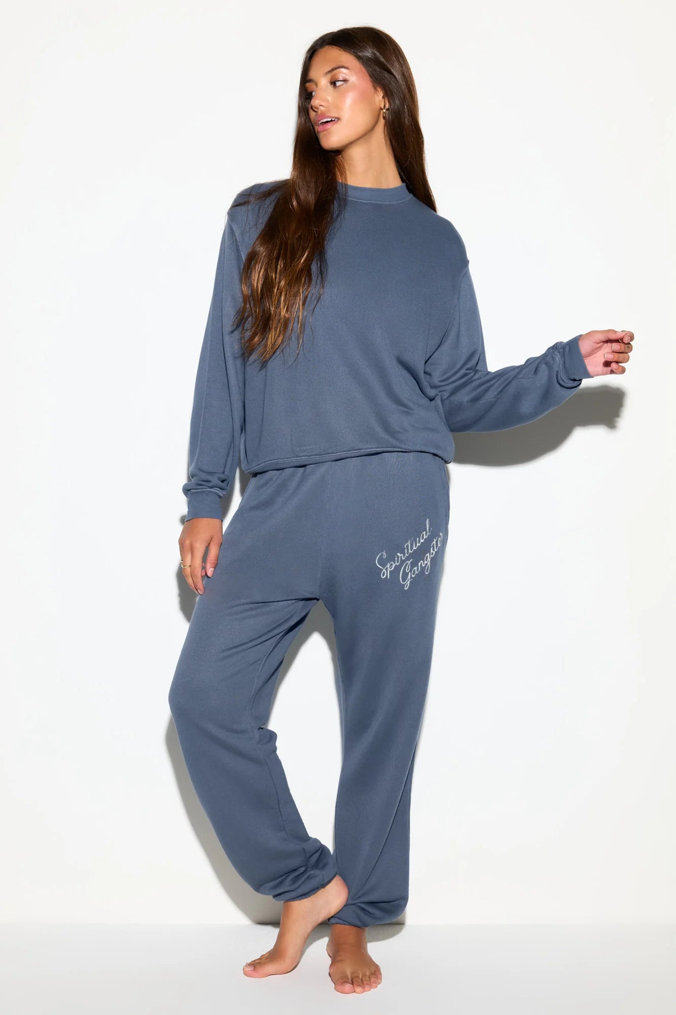 a blue sweatshirt with the logo on the back shoulder