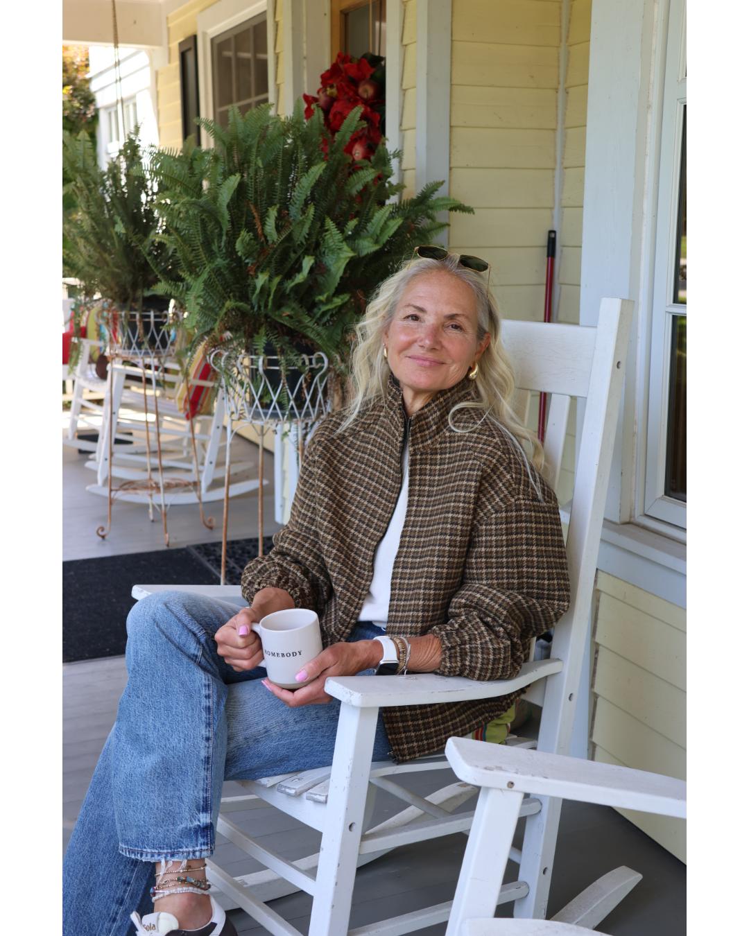 woman wearing a plaid jacket with jeans and sunglasses