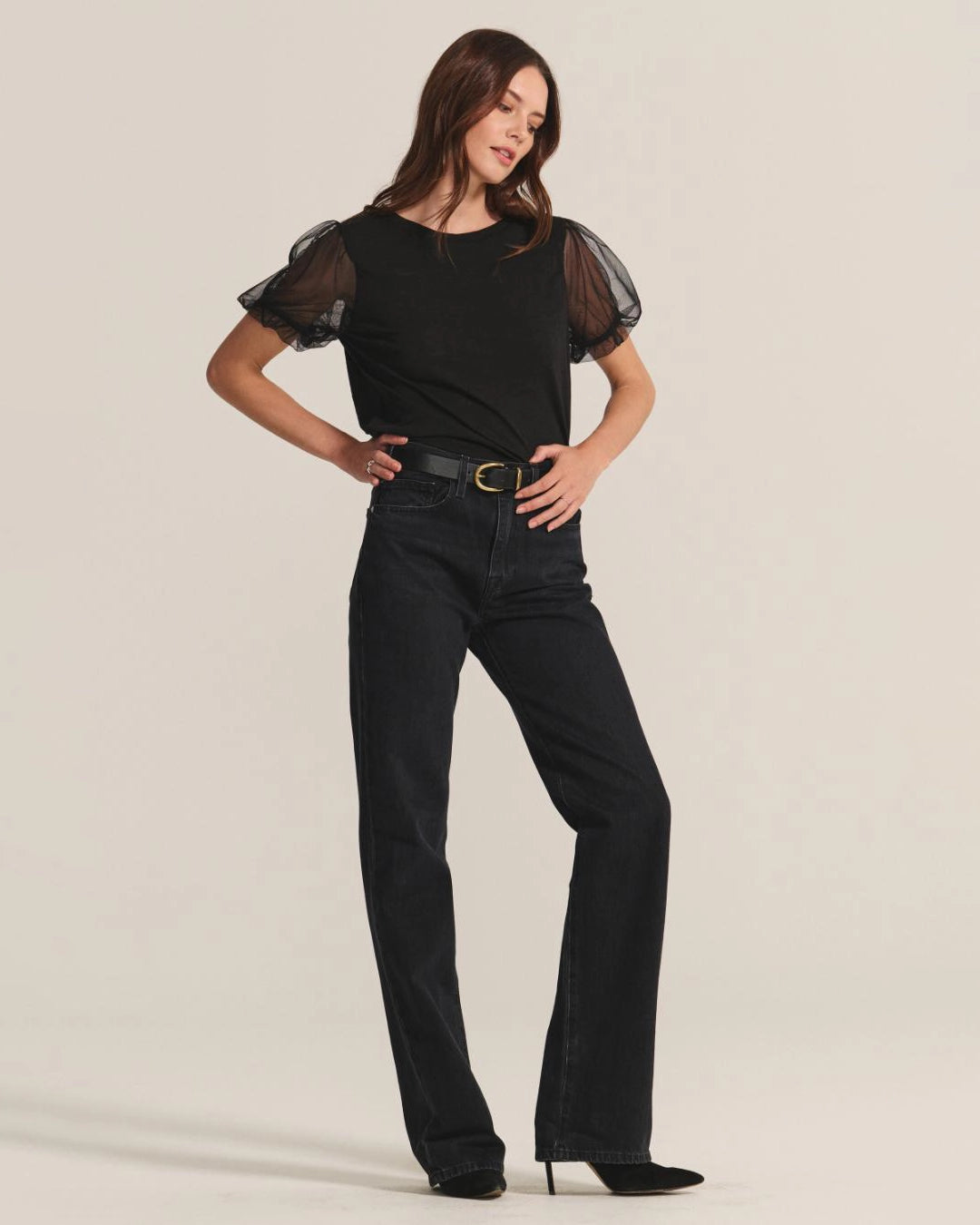 Woman wearing a black top with sheer puff sleeves