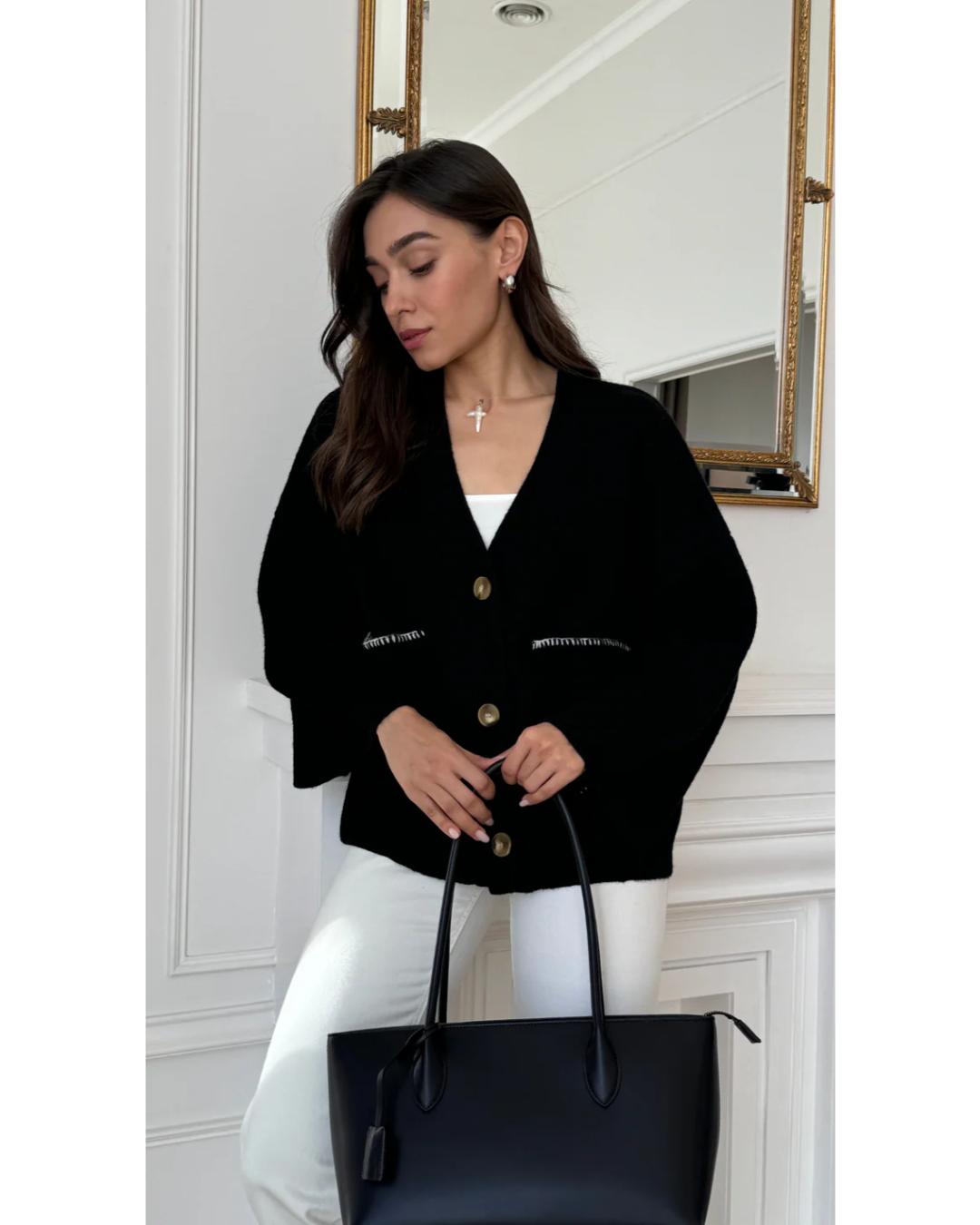 black cardigan with white stitching on the pockets