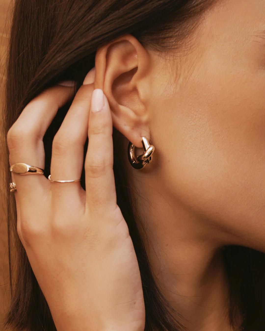 gold hoops in the shape of a knot