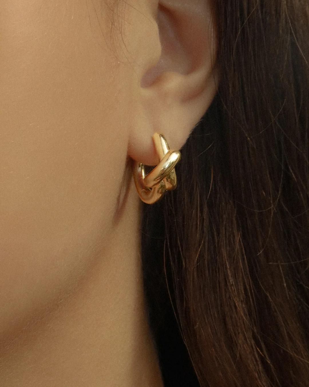 gold hoops in the shape of a knot