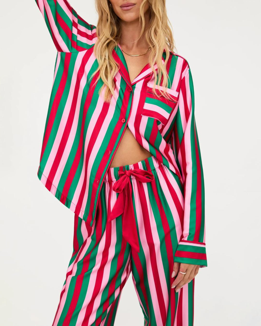 Woman wearing a red, green and pale pink striped pajama set