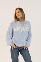 blue knit sweater with apres written on the front