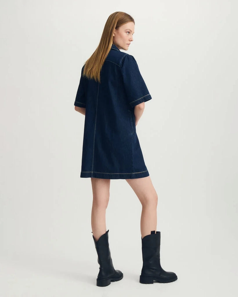 Woman wearing a blue denim dress with black boots